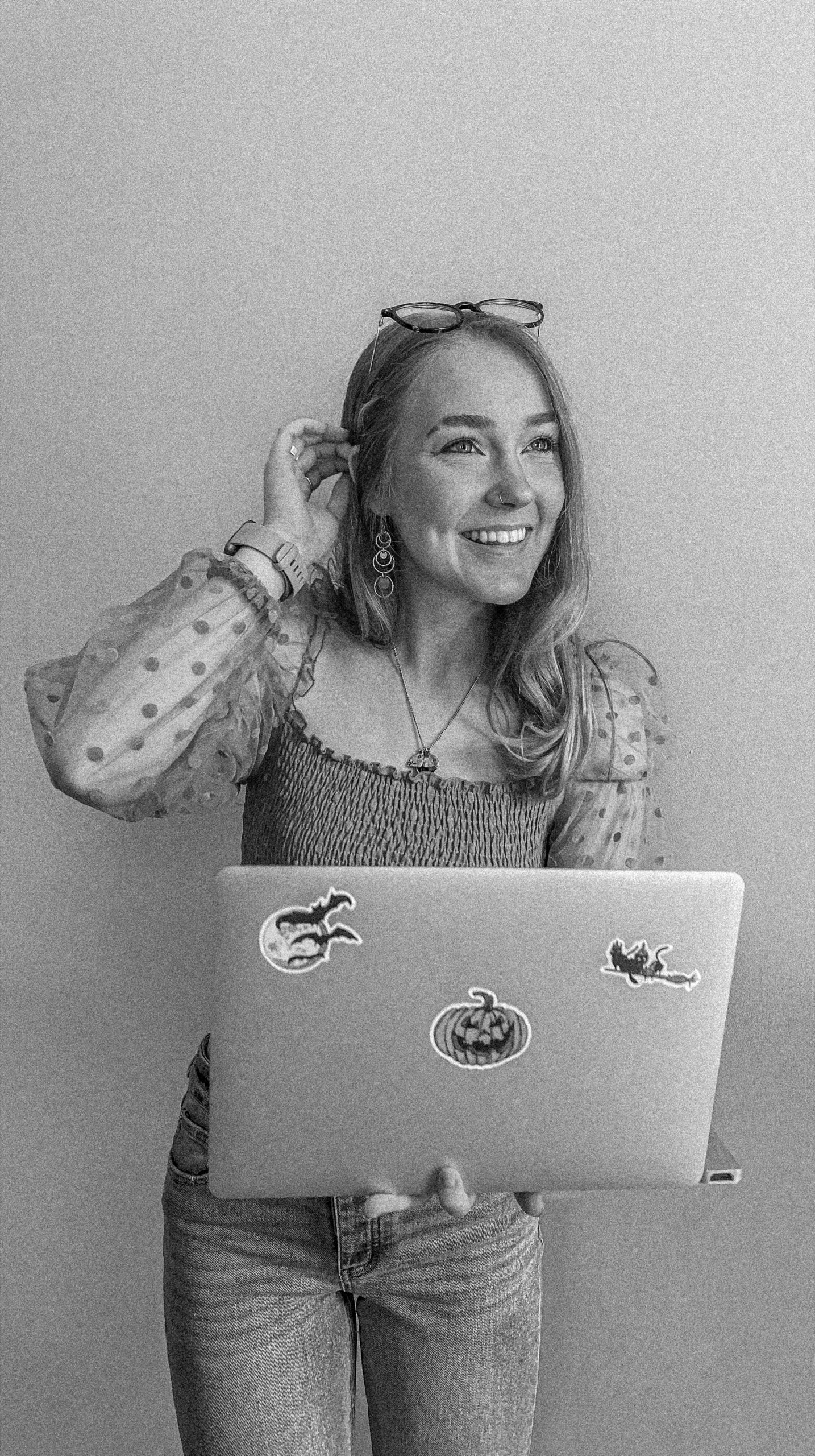 Jenna Rothwein holding her laptop and smiling.