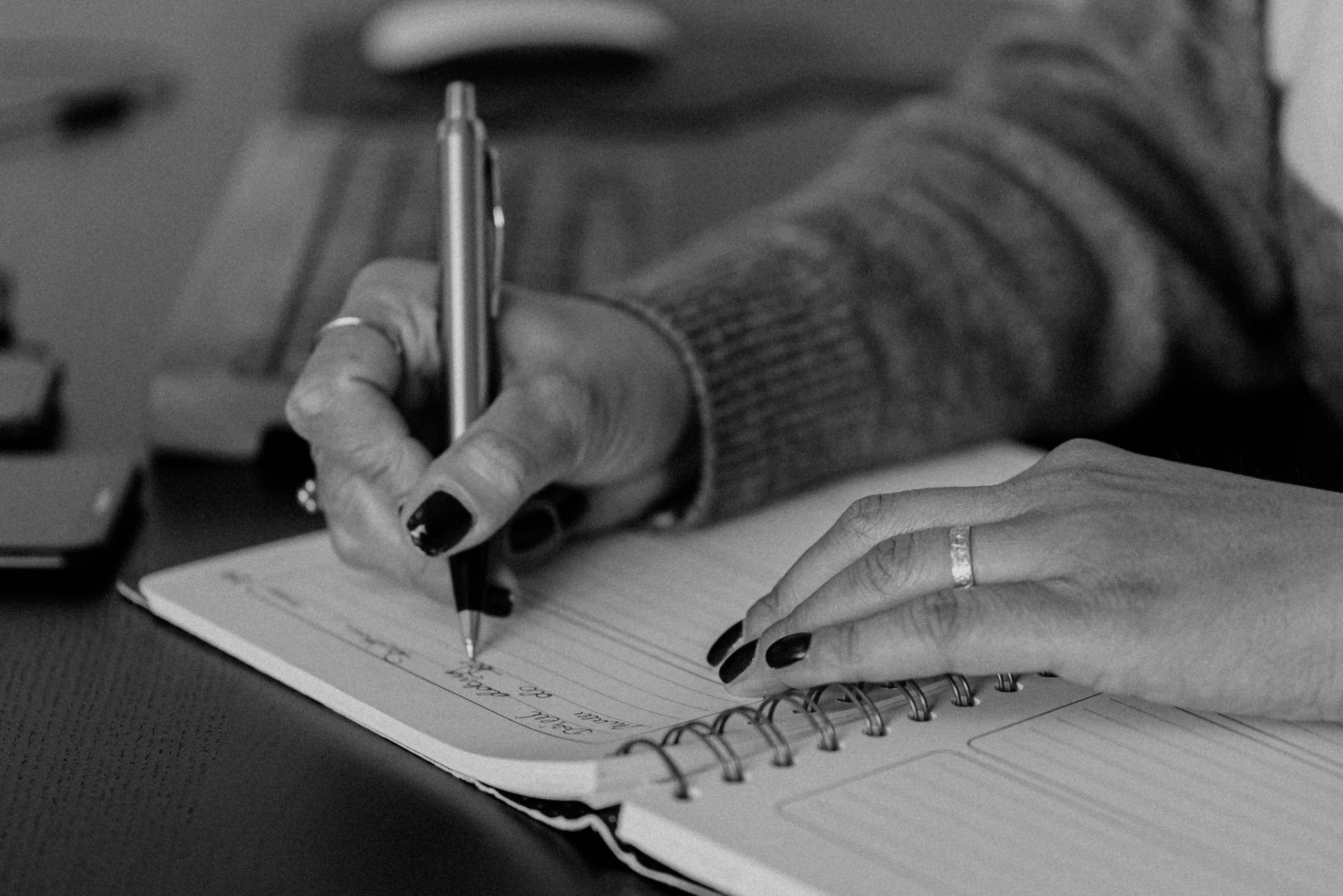 Woman writing in her planner.